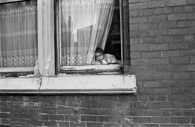 Baby propped in window of Liverpool 8 house 1969